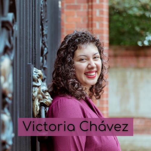 photo of Victoria Chávez, a Latina computer scientist wearing a pretty burgundy shirt standing next to a lion thingy