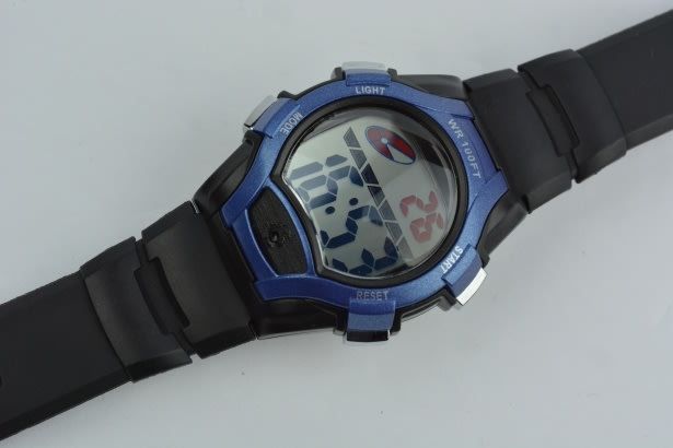 blue wrist watch with a digital display that says 16:53