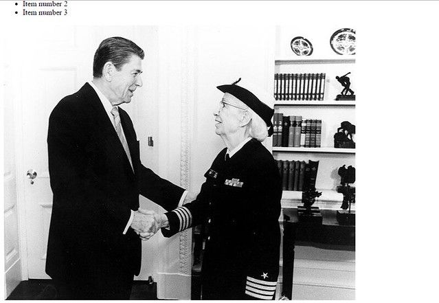 Grace Hopper and Ronald Regan shaking hands at the White House