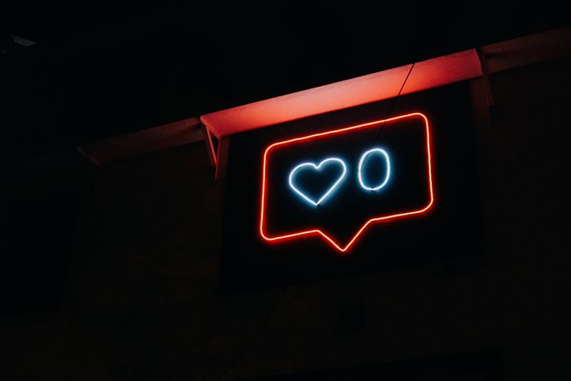 Red and white neon sign with a heart and zero.